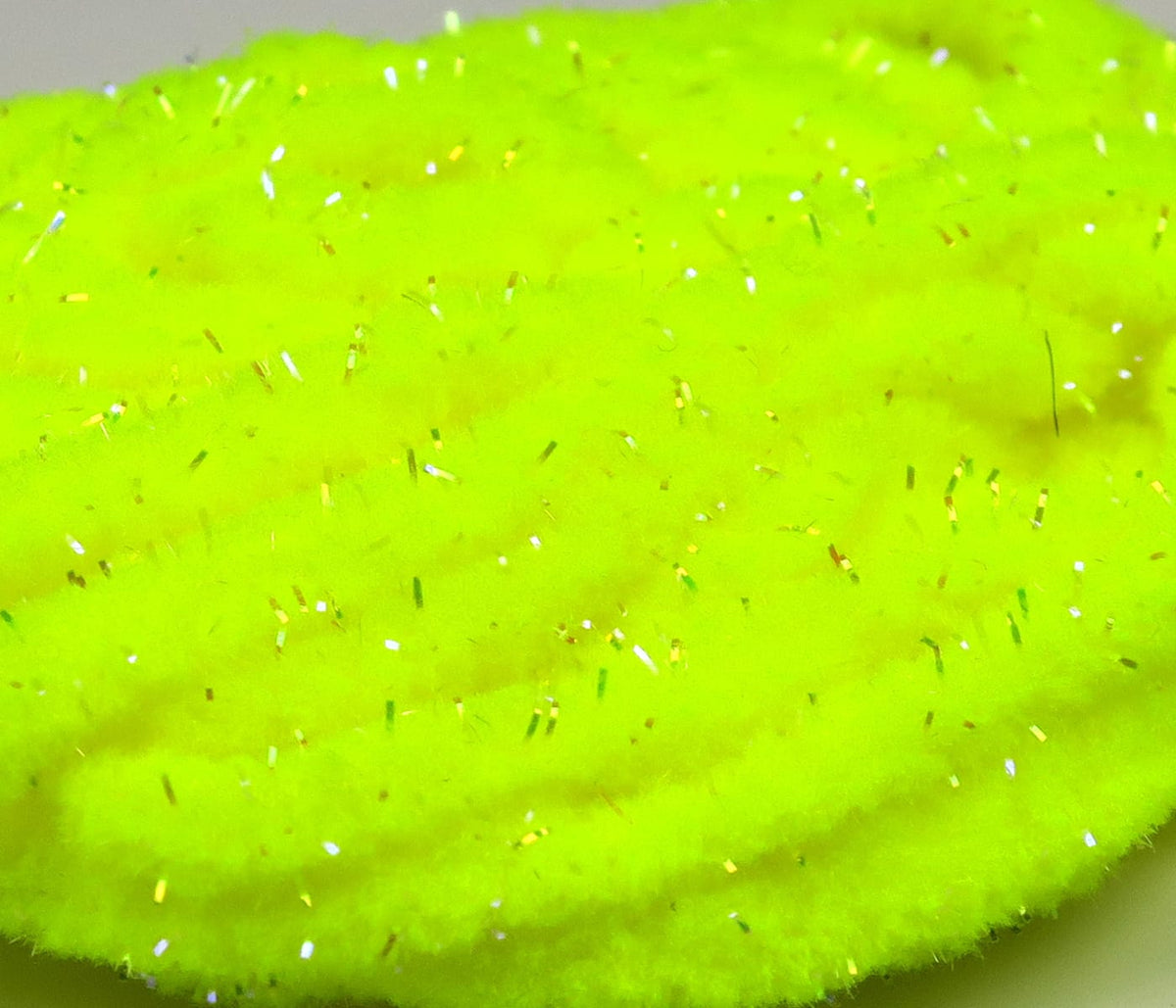 UV Galaxy mop chenille in fluorescent chartreuse synthetic fibers with iridescent tinsel strands for fly tying