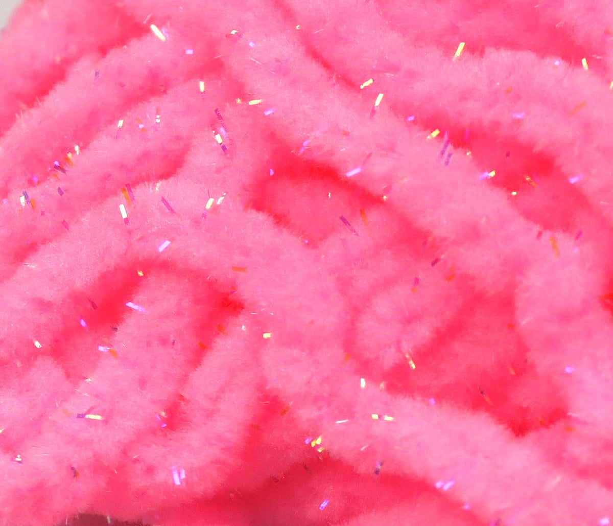 Hot pink Hareline UV Galaxy mop chenille, fluffy chenille strands with iridescent tinsel for fly tying
