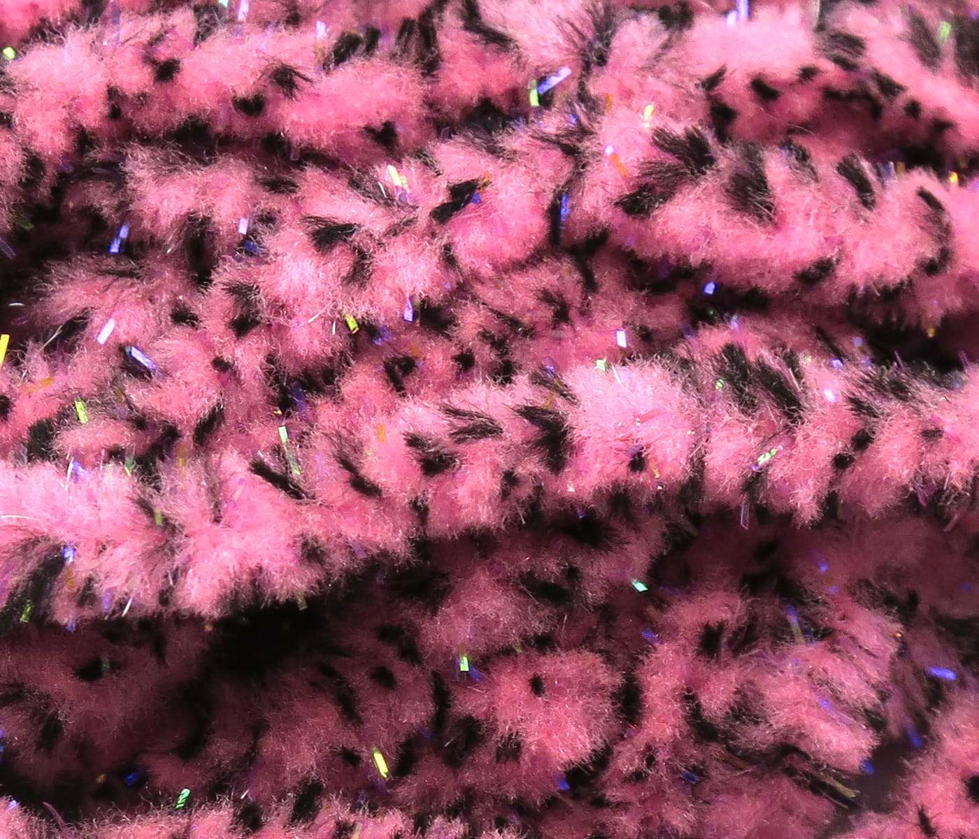 Pink UV mottled galaxy mop chenille with black flecks and iridescent tinsel, fluffy fly tying material