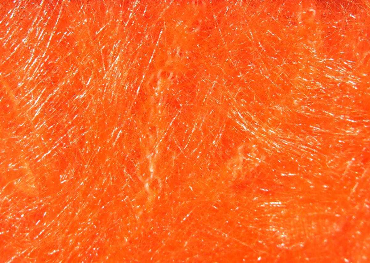 Bright orange Hareline wire-free synthetic fox brush with glossy long bushy fibers for fly tying
