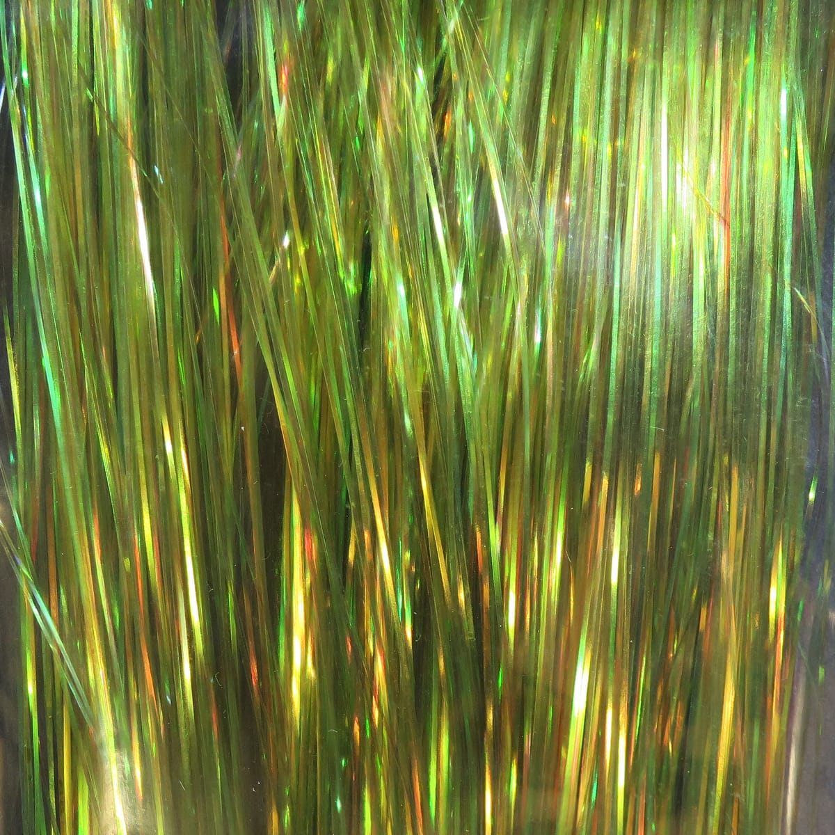 Iridescent green-gold dyed pearl Flashabou strands for fly tying, thin reflective synthetic tinsel