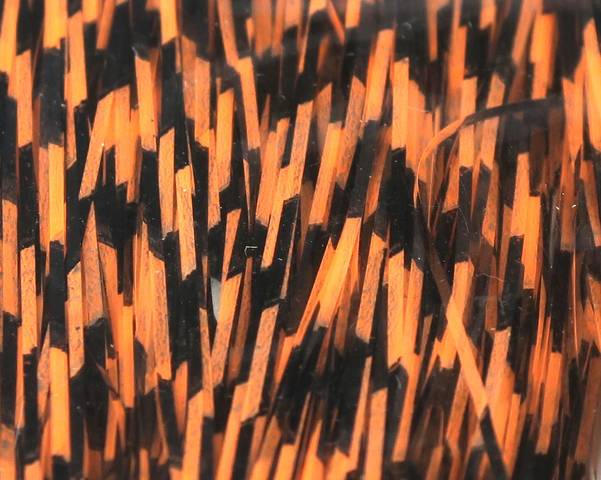 Grizzly-barred orange and black Flashabou strands, glossy synthetic magnum fibers with bold striping for fly tying