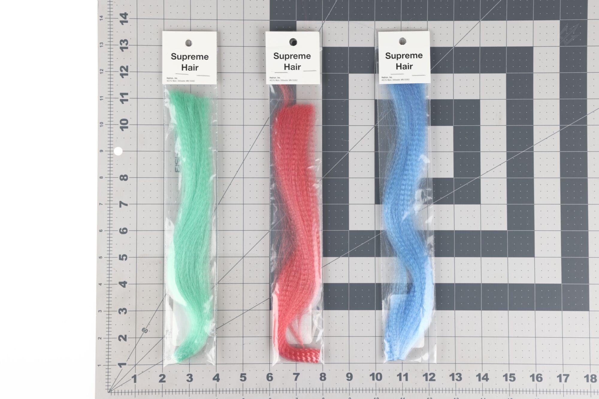 Three Hedron Supreme synthetic hair for fly tying: mint green, red and sky blue fibers on white header cards