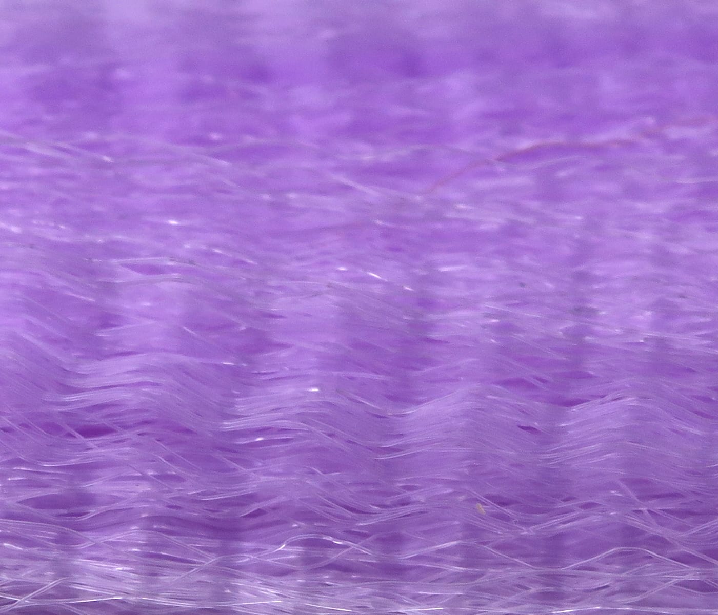 Lavender purple synthetic fly tying hair with fine wavy glossy fibers and dense stacked strands.