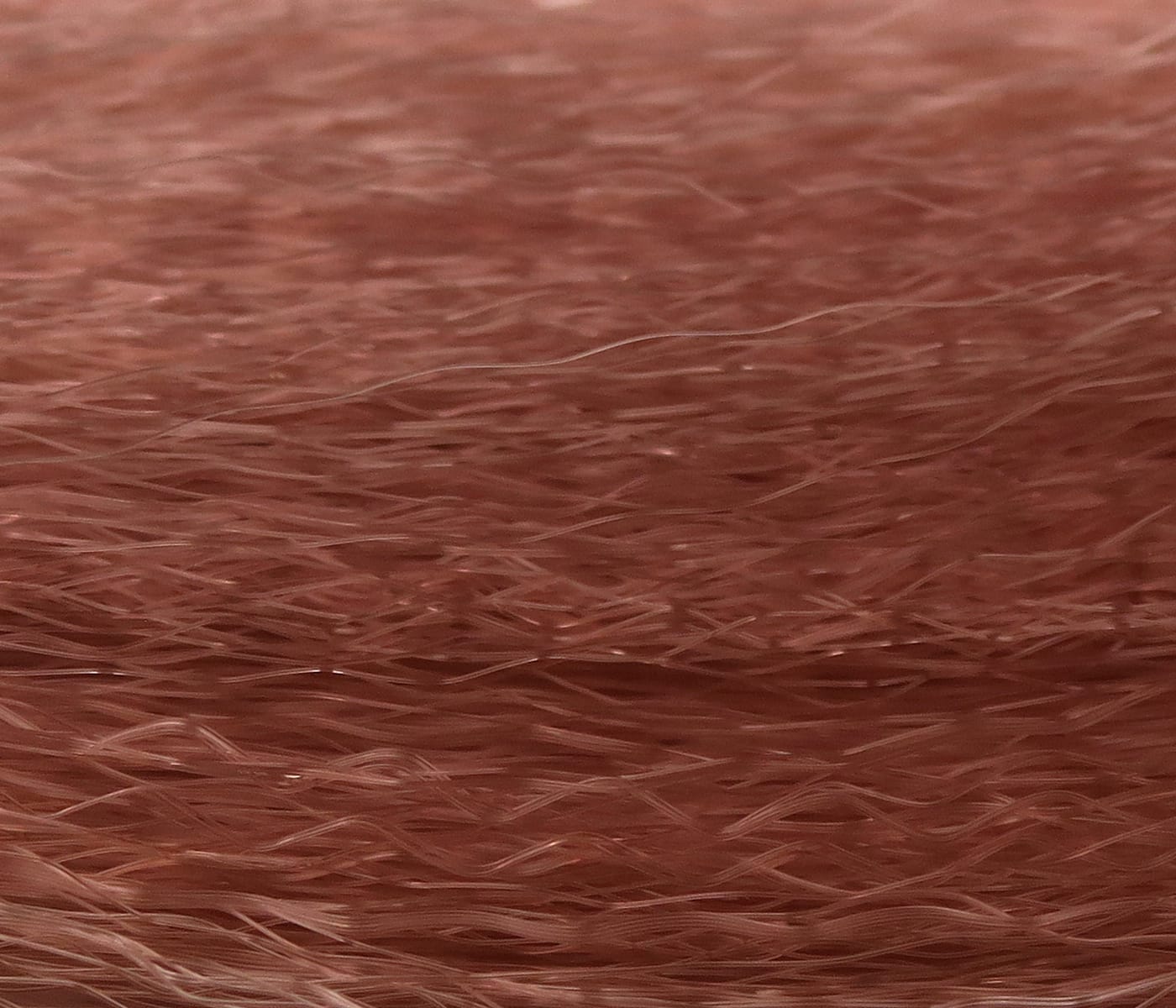 Reddish-brown synthetic fly tying hair with fine translucent fibers layered for lifelike streamer and nymph bodies