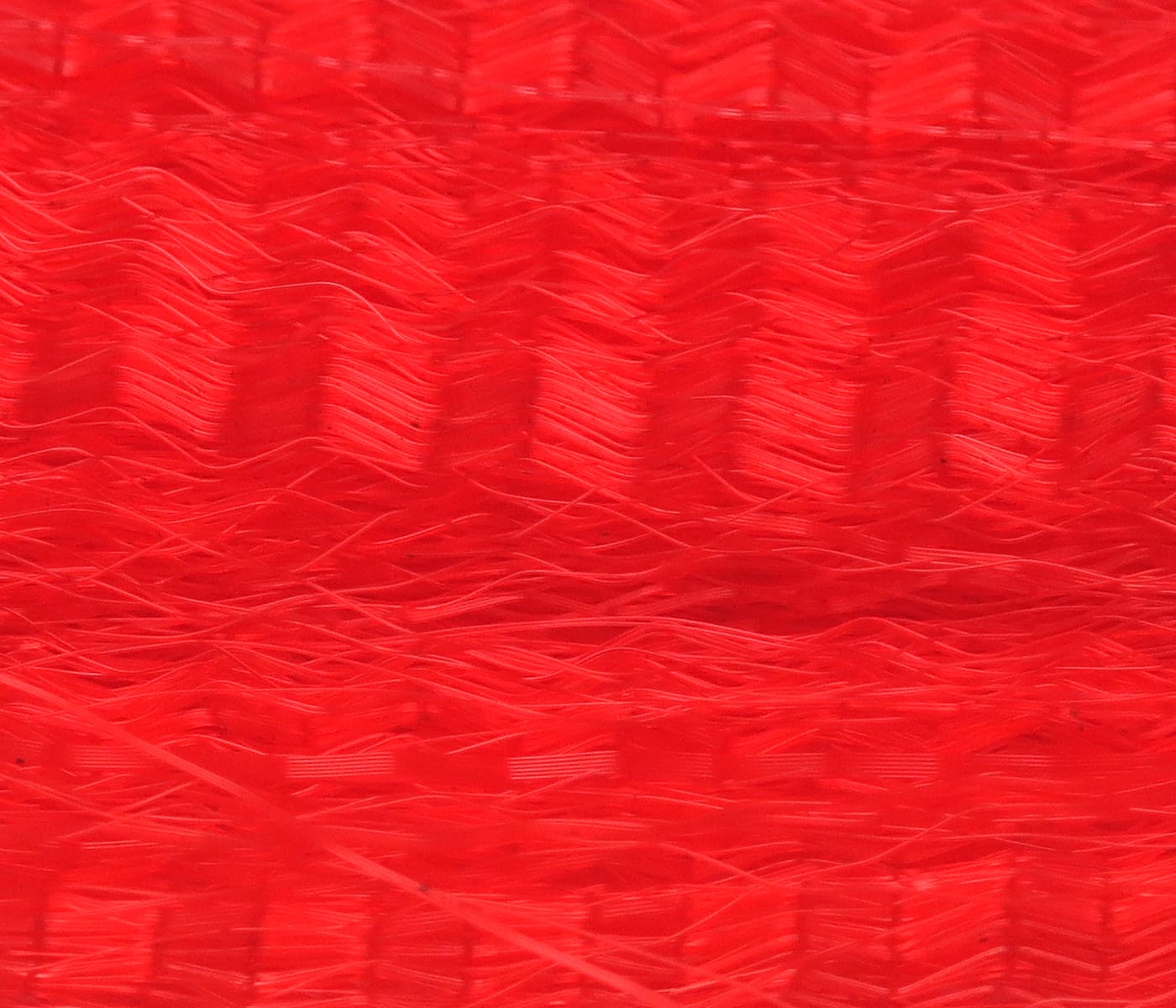Bright red synthetic hair fibers with wavy layered texture for fly tying lures