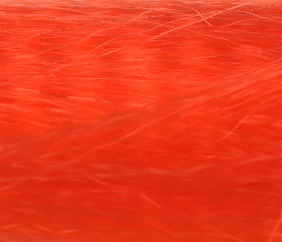 Bright fluorescent orange synthetic fly tying hair, Hedron Unique Hair showing fine wispy fibers and smooth texture