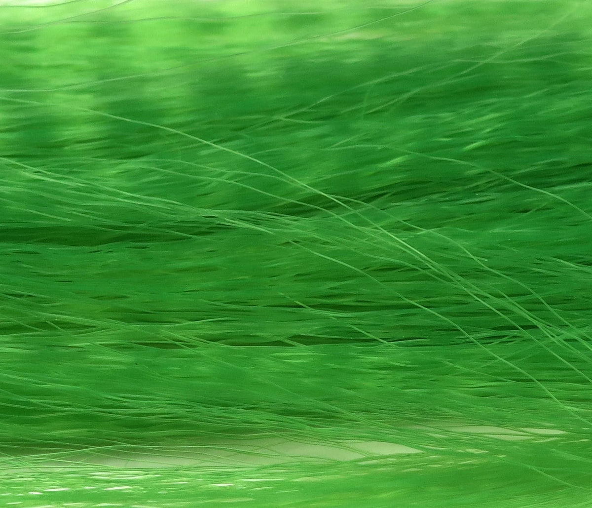 Bright green synthetic fly tying hair with long fine strands, Hedron Unique Hair for streamers