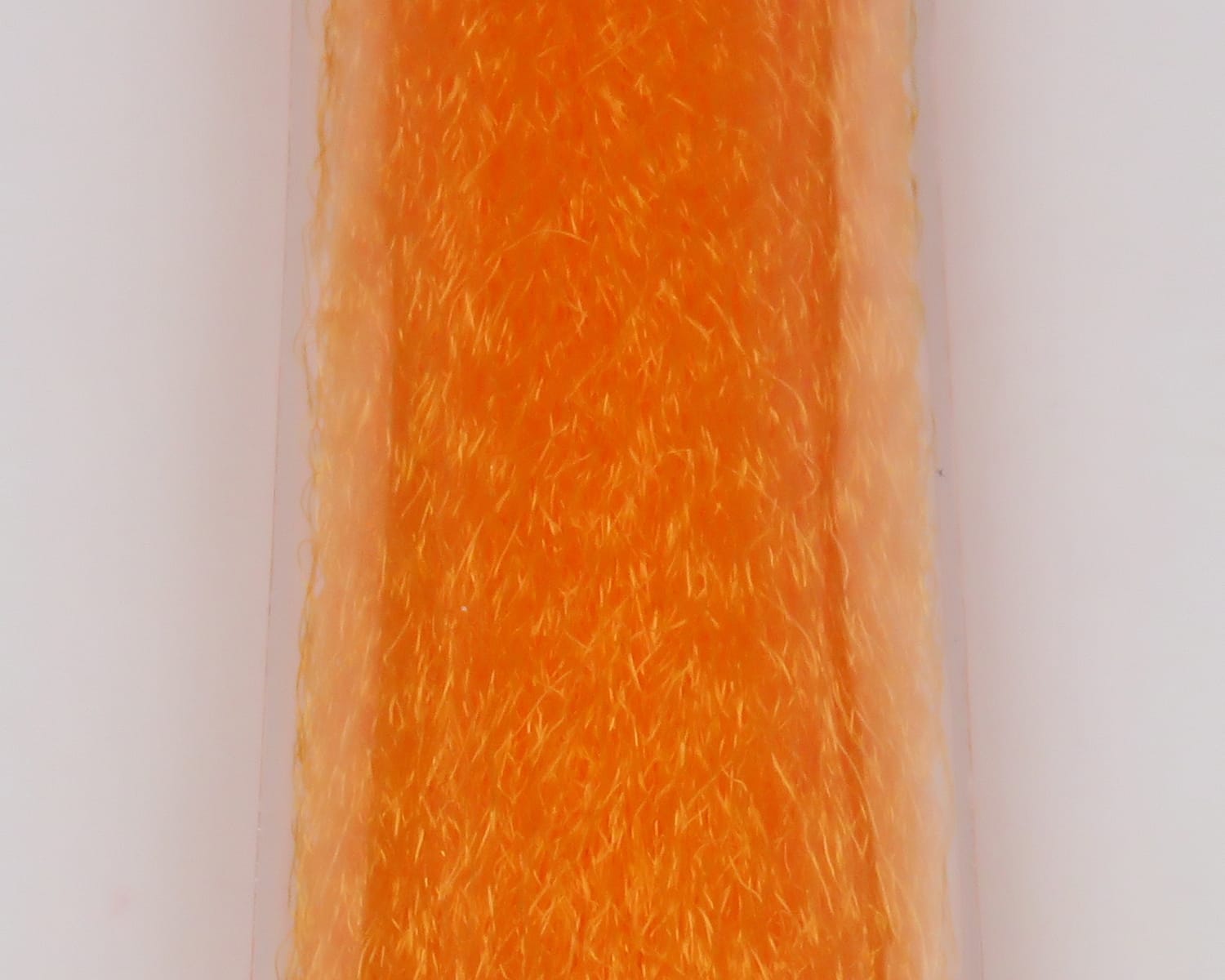 Bright orange slinky fibre with fine crinkled synthetic strands, plush textured strip for fly tying