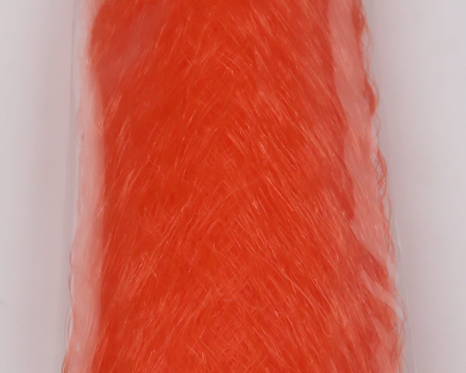 Bright orange slinky fibre bundle with glossy, wispy synthetic strands for fly tying