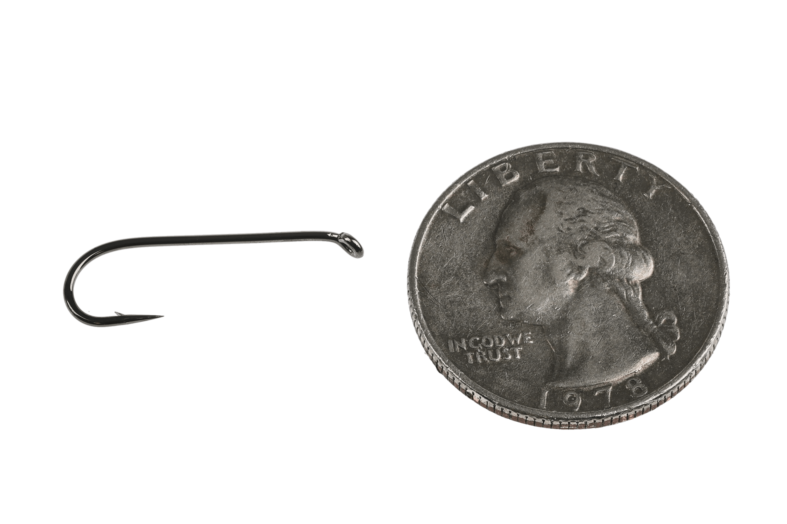 Gunmetal Kona NS2 2XL nymph streamer hook with long shank and upturned eye beside U.S. quarter for scale fly tying