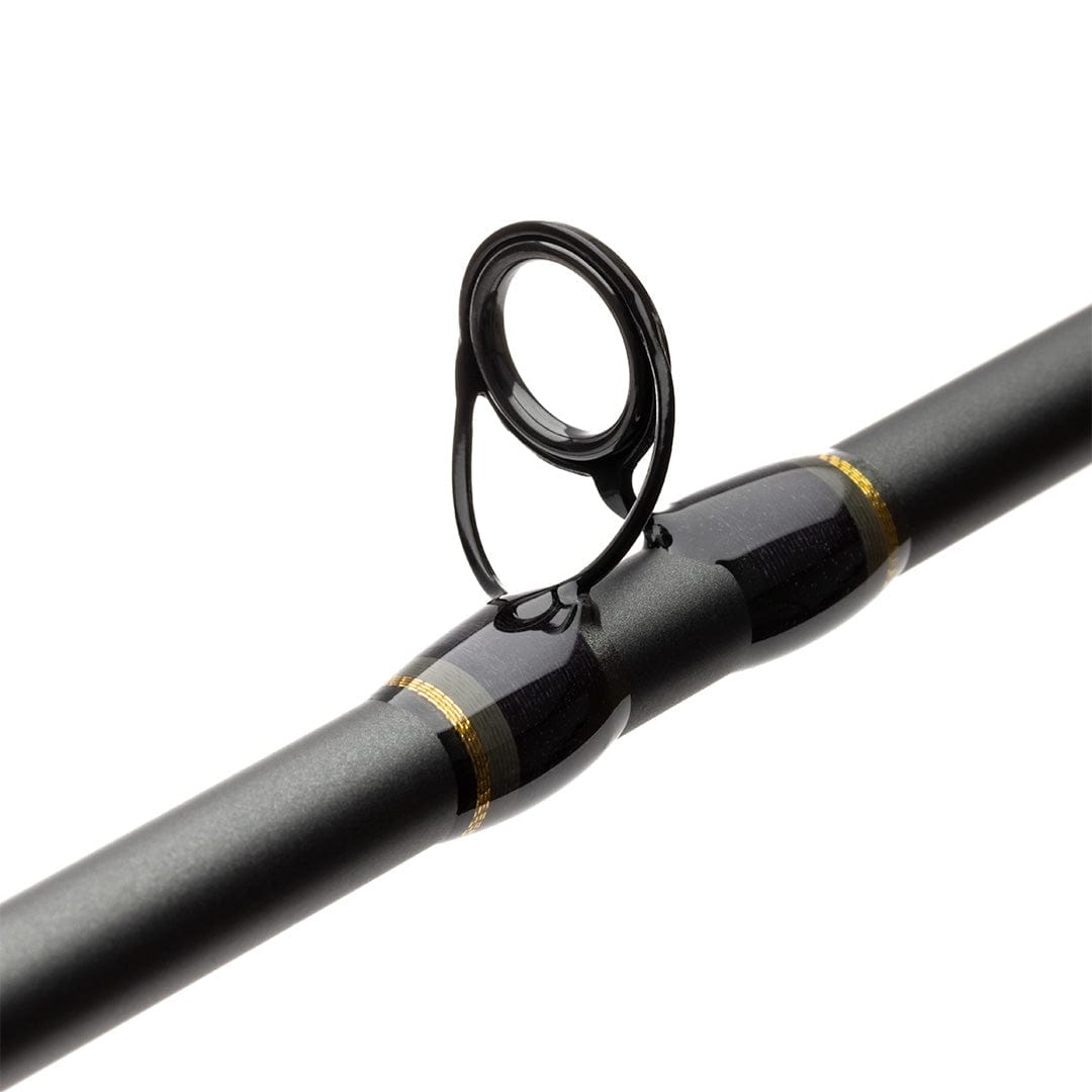 Close-up of Lamson Speedster fly rod guide on matte black blank with glossy black guide frame and gold thread wraps