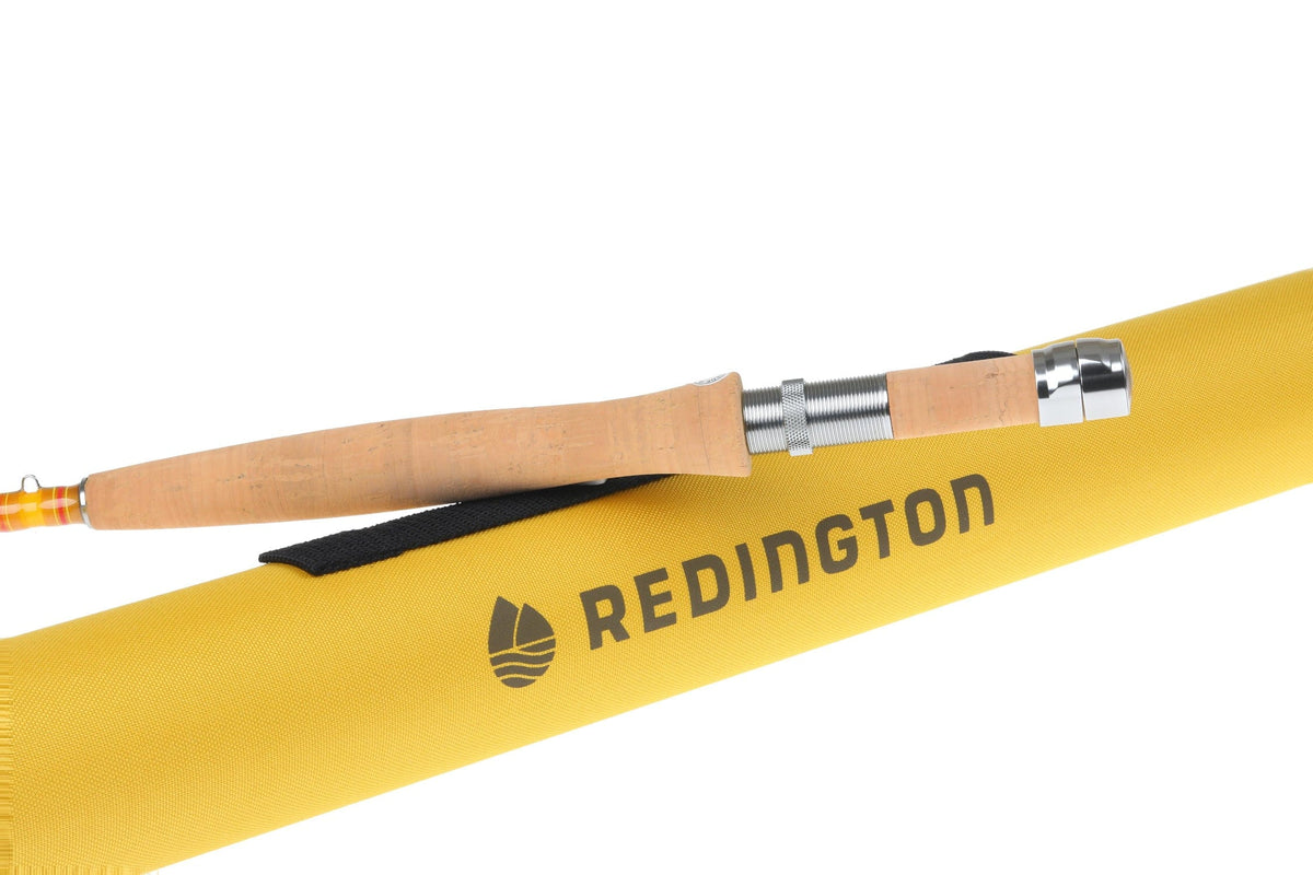 Redington Butter Stick fly rod cork handle with chrome reel seat resting on yellow Redington rod tube