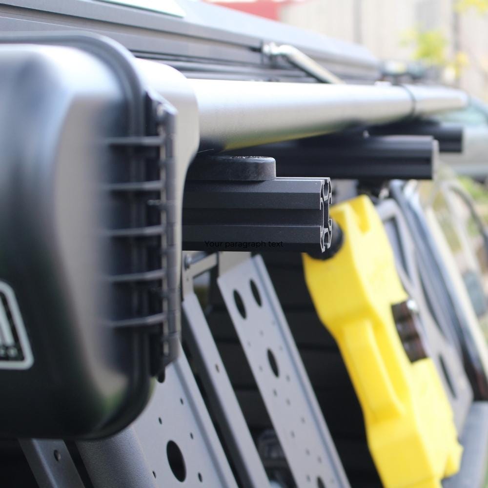 Riversmith Low-Profile T-Track Mount black rod rack accessory installed on yellow vehicle roof rails