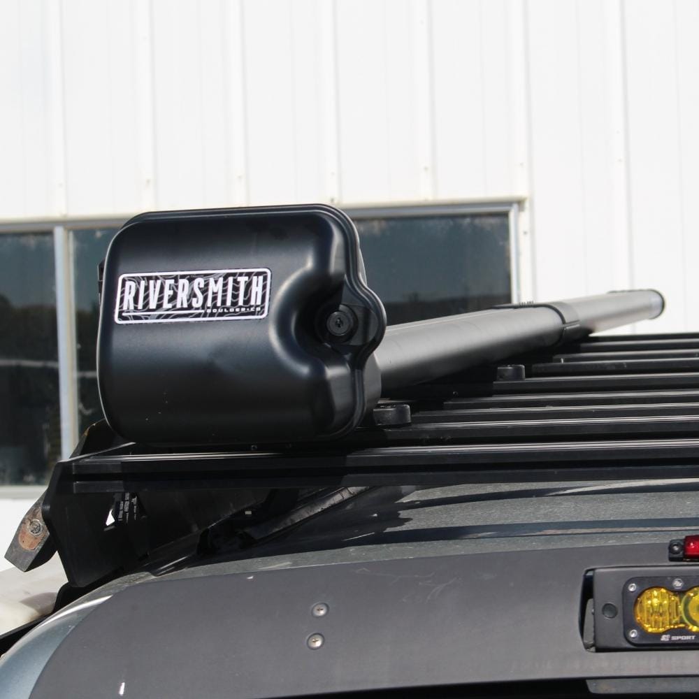 Riversmith black low-profile T-track rod rack mount on truck bed with fishing rods