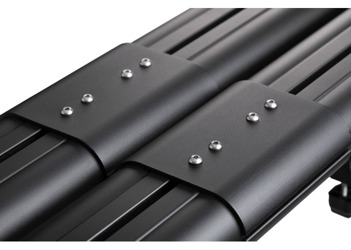 Black aluminum fishing rod holder with metal fasteners securing multiple rods to vehicle roof rack