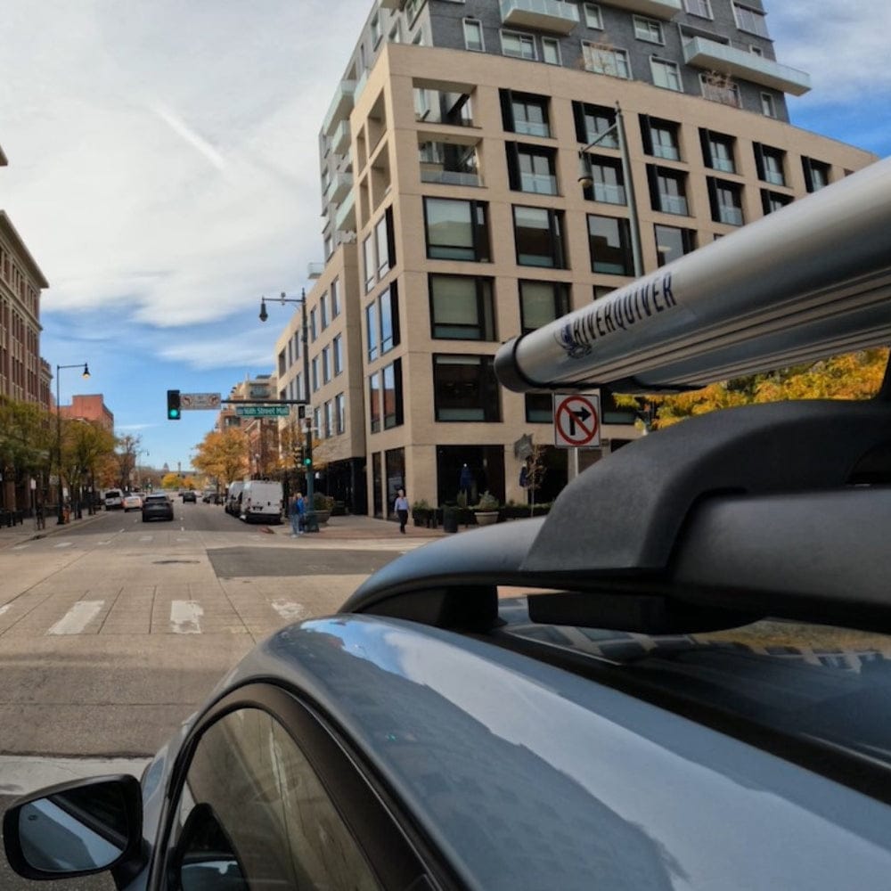Riversmith ShortCut river quiver fishing rod rack mounted on vehicle roof rack in urban street setting