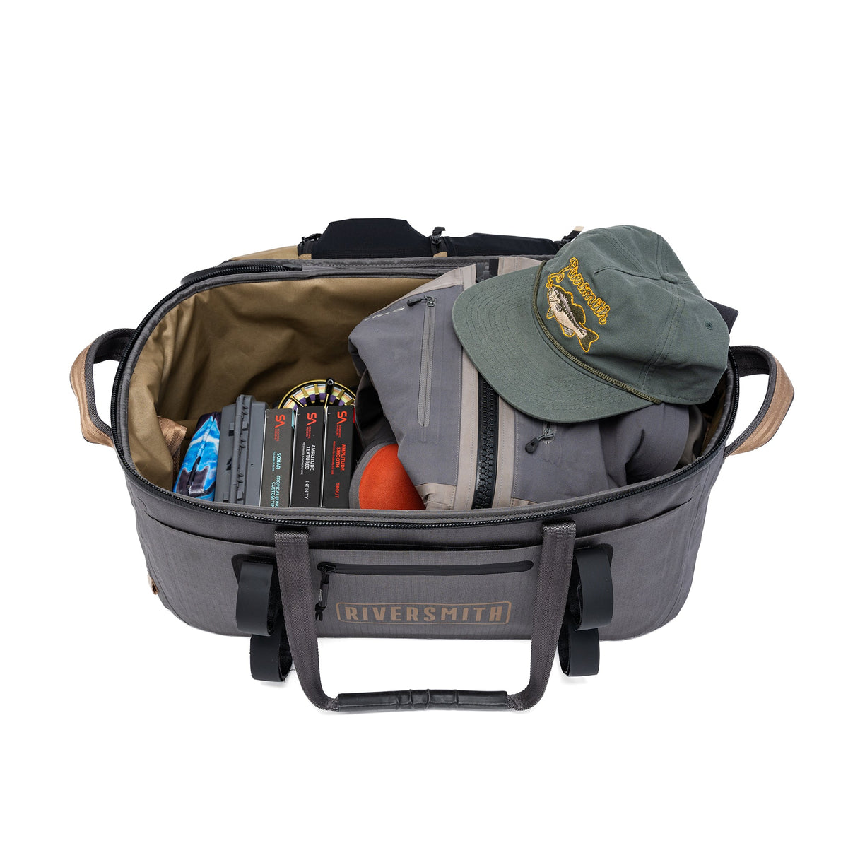 Riversmith gray waterproof duffel bag open showing interior pockets, fishing gear, and green cap
