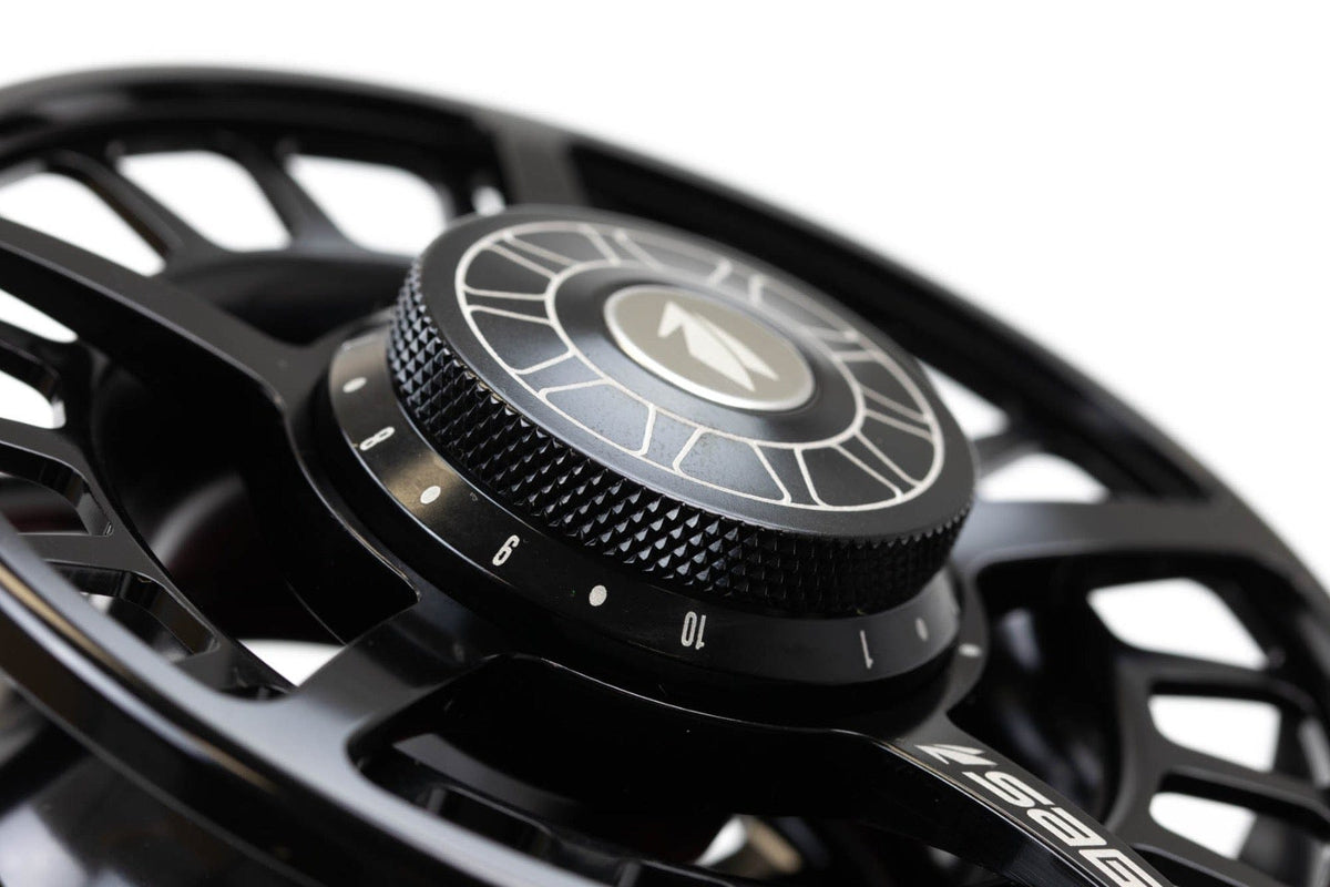 Matte black Sage Spectrum fly reel showing machined alloy skeleton spool and knurled drag knob with numbered settings