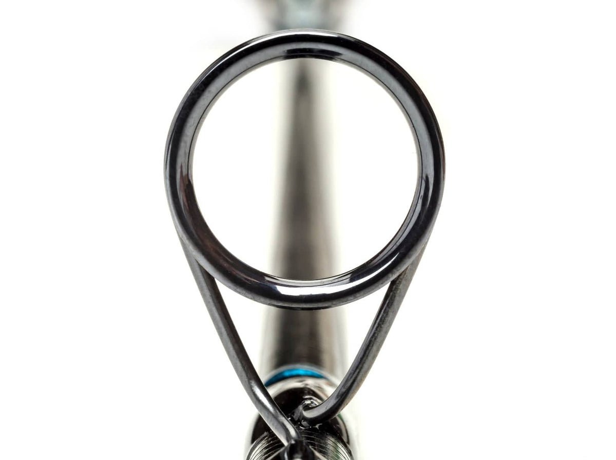 Black metal guide ring on graphite grey Scott Sector fly rod blank with blue thread wrap