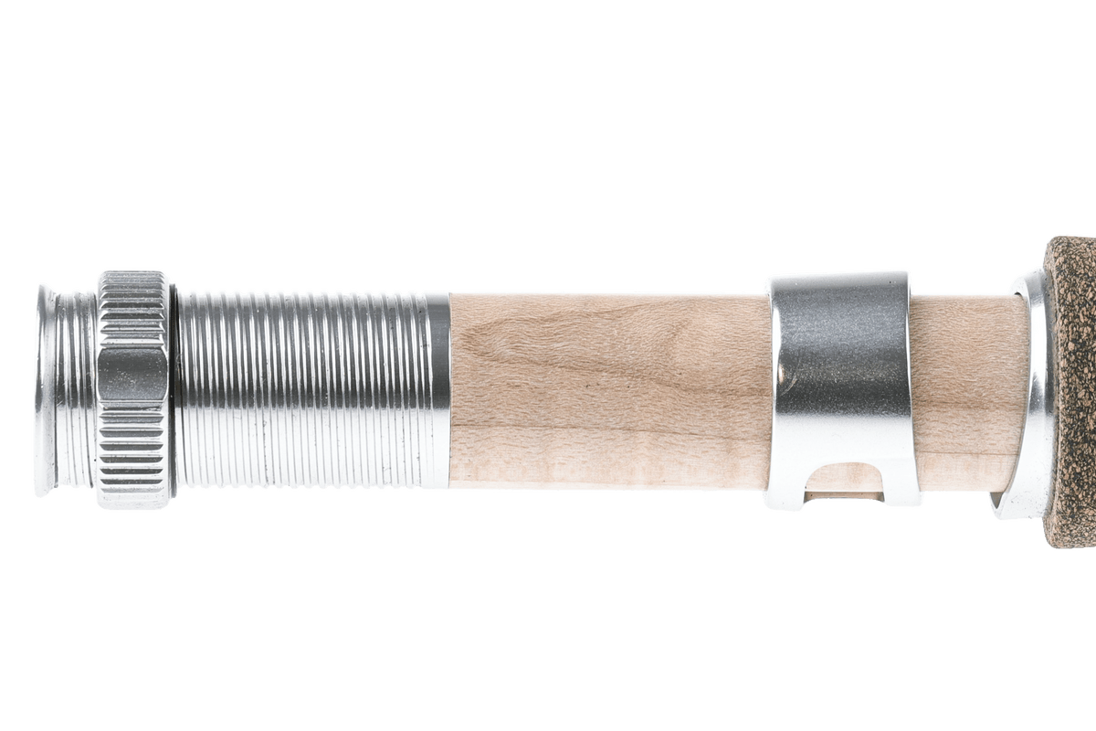 St. Croix Technica fly rod handle detail showing cork grip, metal reel seat, and threaded components in natural wood tones