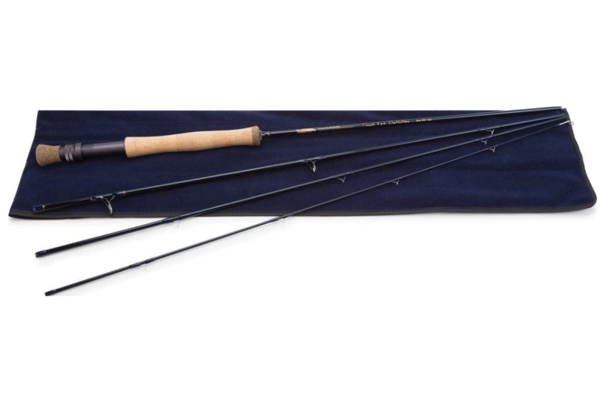 TFO Clouser fly rod with cork handle and black case, displaying complete fishing rod set on navy blue cloth background