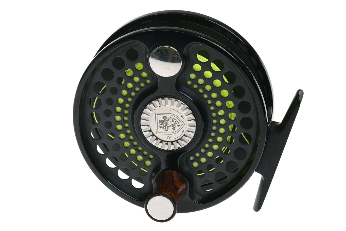 Black anodized fly reel with perforated spool, neon green line visible, silver drag knob and wooden handle