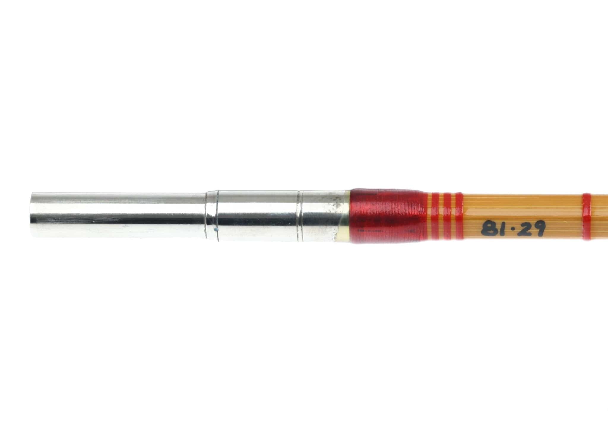 H.L. Leonard Centennial bamboo fly rod section with silver ferrule, amber blank and red thread wraps labeled 81-29