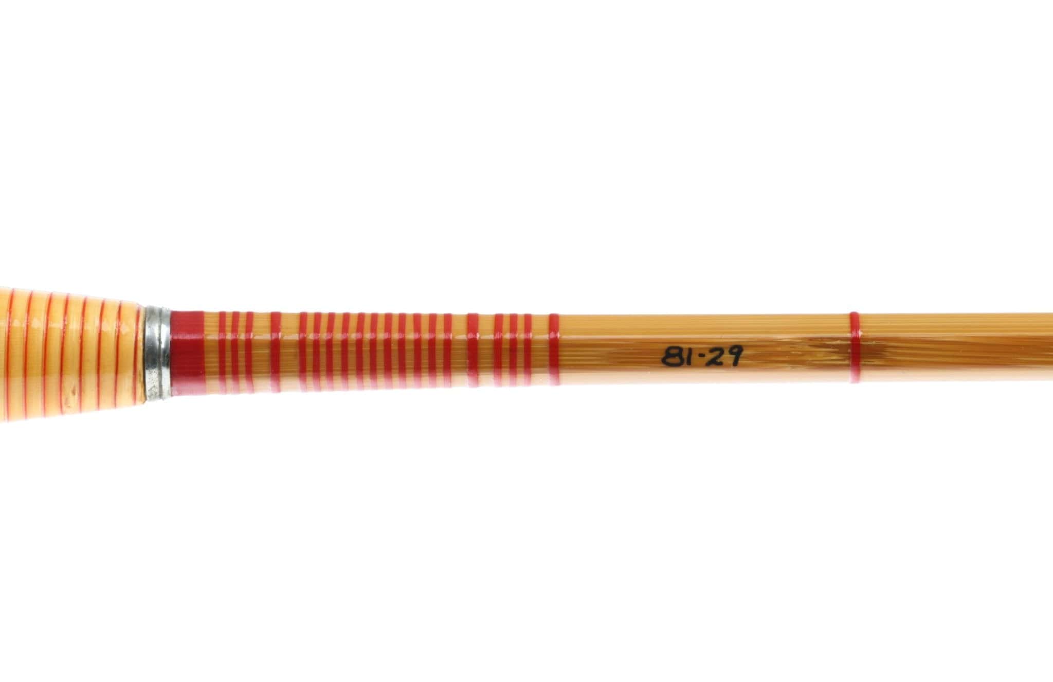 Amber bamboo fly rod section with red thread wraps, cork handle, nickel silver winding check and black 81-29 marking