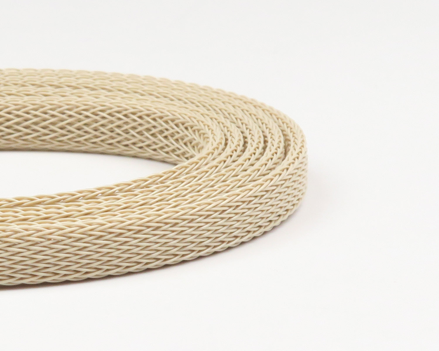 Coiled cream braided nylon mesh body tubing for fly tying with tight woven tubular pattern