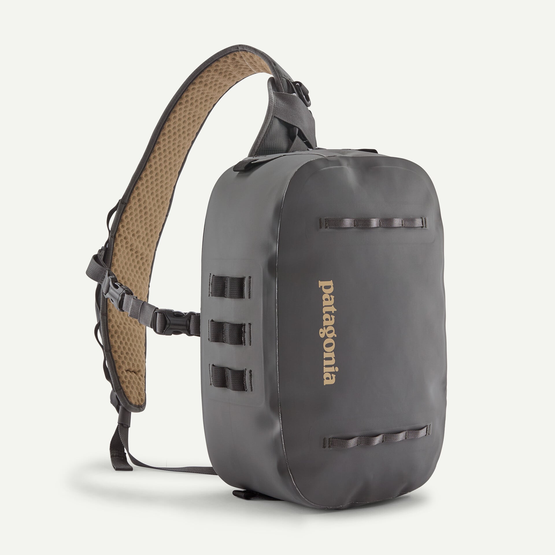 Slate gray Patagonia Guidewater Switch Pack sling with welded waterproof shell and tan honeycomb padded shoulder strap
