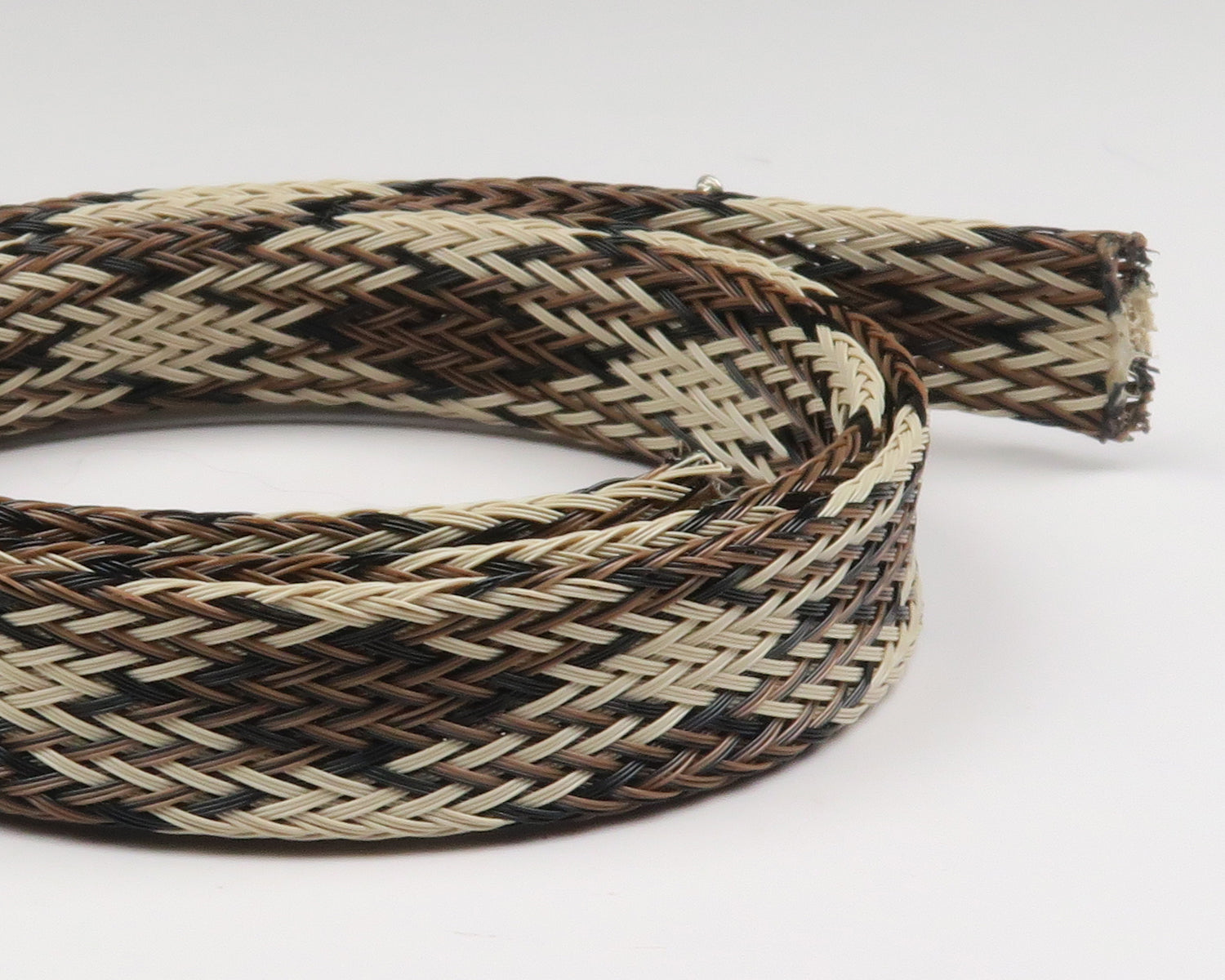 Braided body tubing for fly tying in tan, brown and black woven synthetic strands