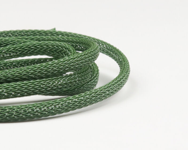 Olive green braided synthetic body tubing coiled on white background, textured hollow tube for fly tying