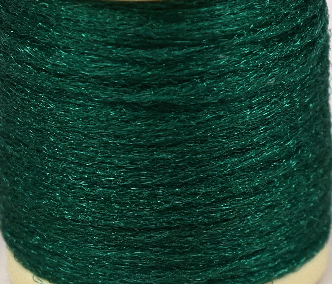 Emerald green Hareline Antron yarn spool with shimmery synthetic fibers, textured fly tying material