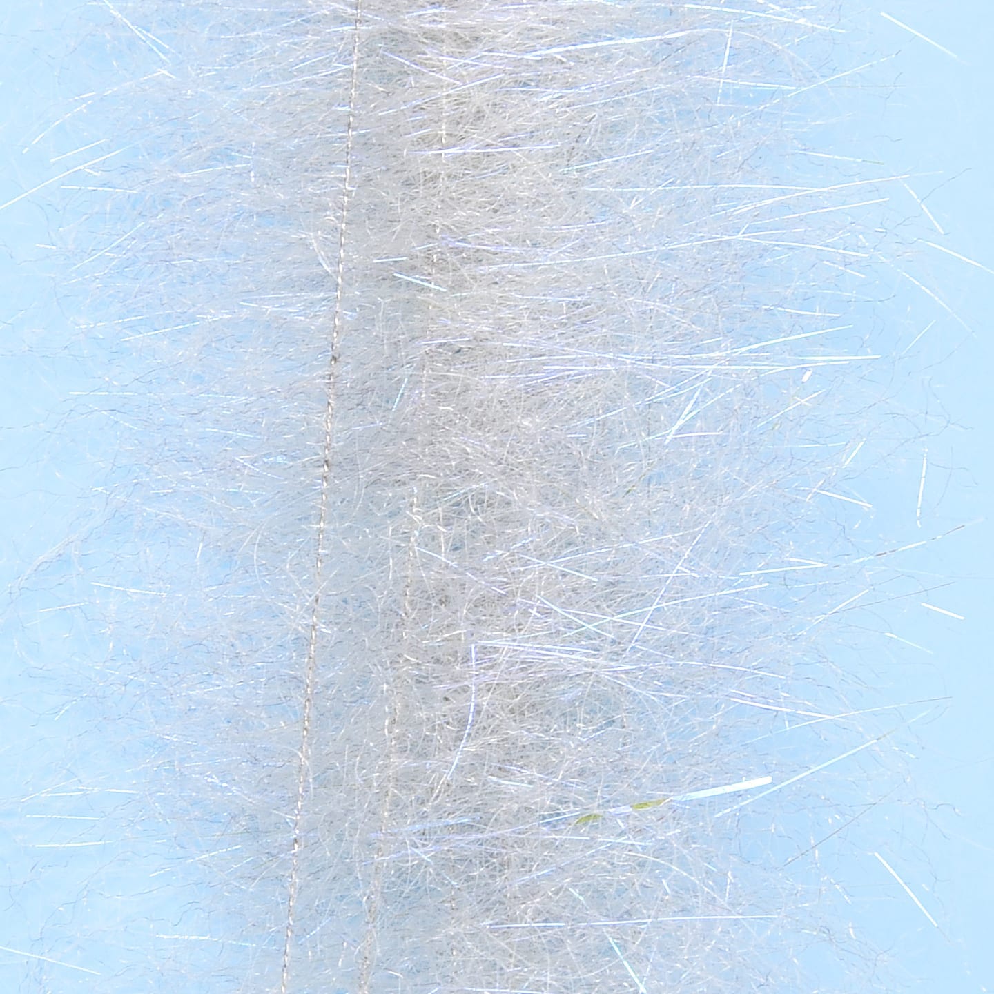 Silver-white synthetic dub brush with fine iridescent flash fibers, fuzzy cylindrical fly tying material
