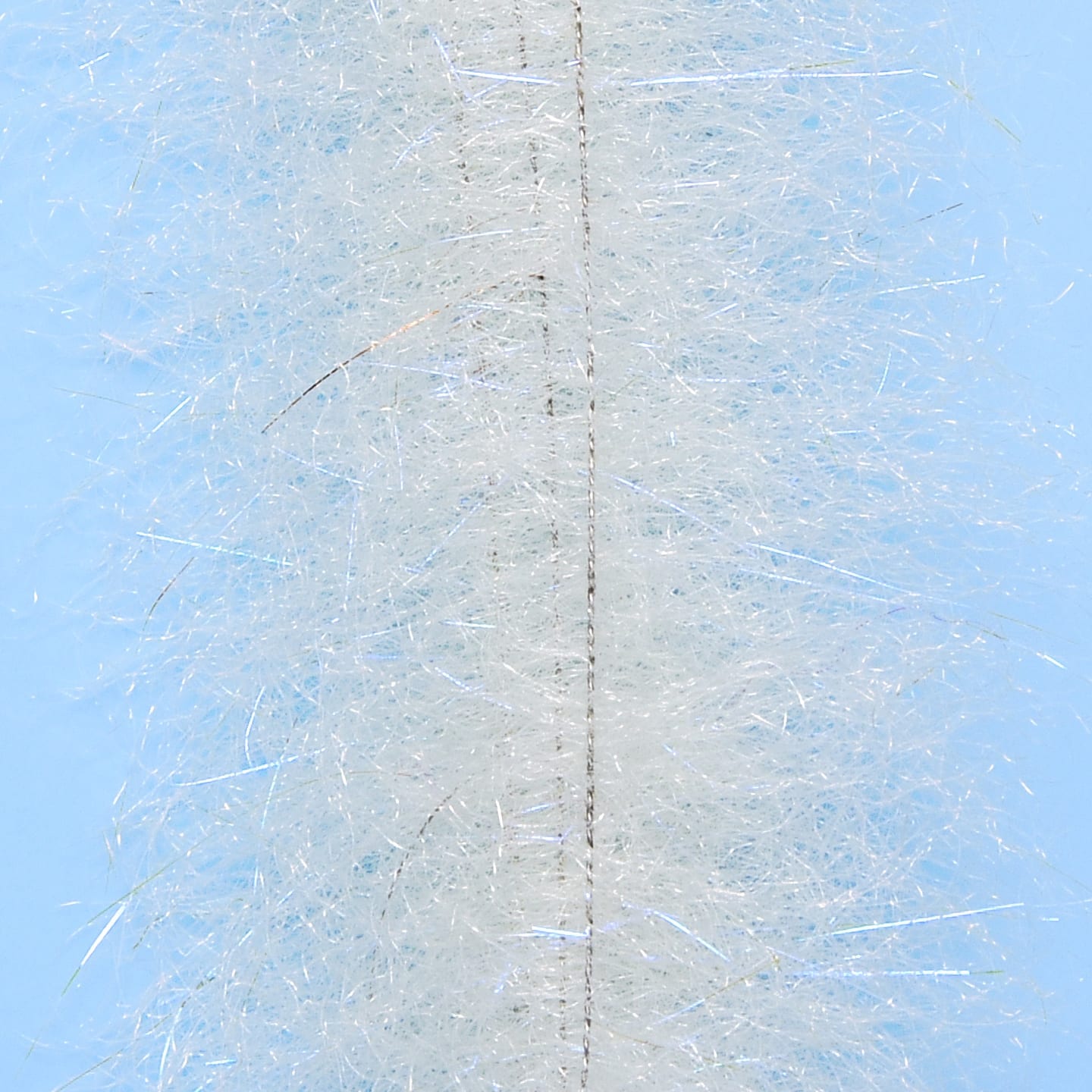 White synthetic shrimp dub brush with dense fluffy fibers, iridescent flash and central wire core for fly tying