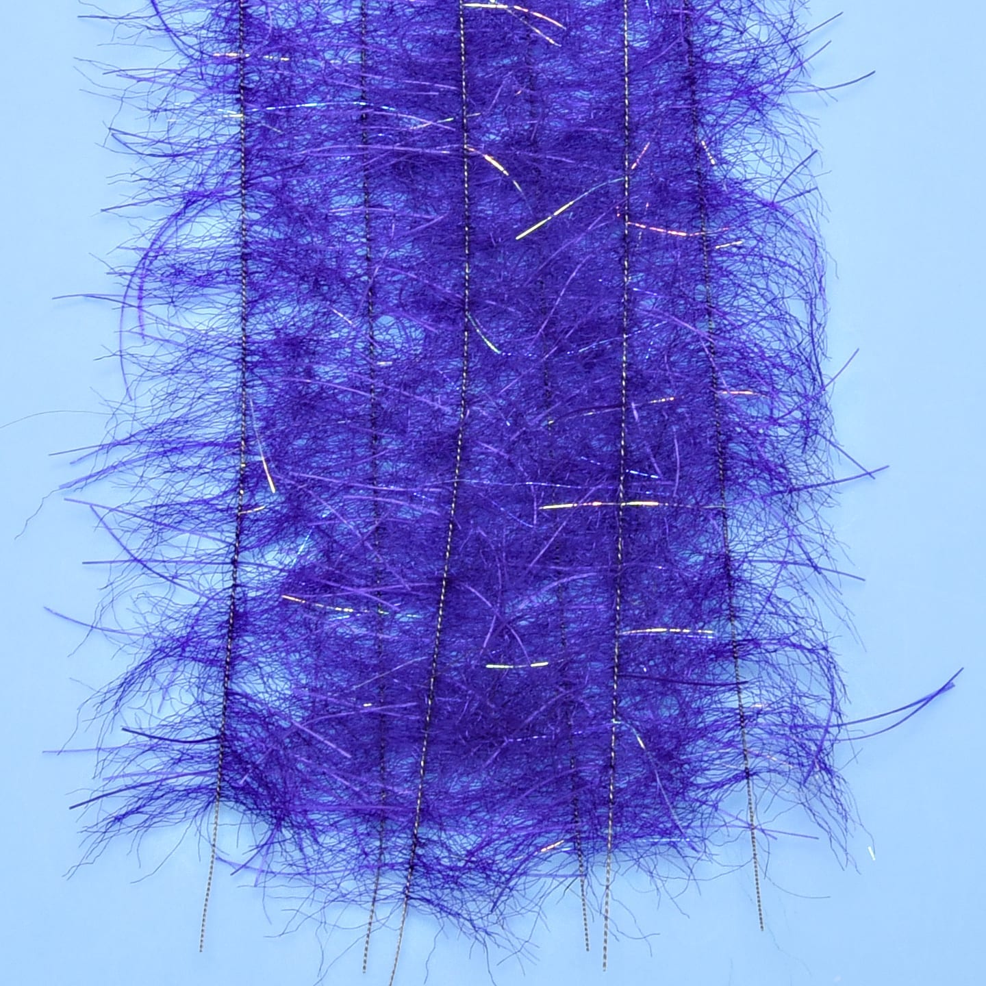 Purple tarantula hairy legs brush with fuzzy synthetic fibers and iridescent tinsel strands for fly tying