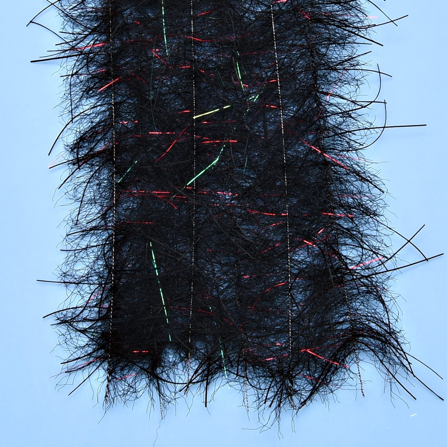 Black Enrico Puglisi Tarantula Hairy Legs brush strip with long fuzzy fibers and red/green flash strands for fly tying