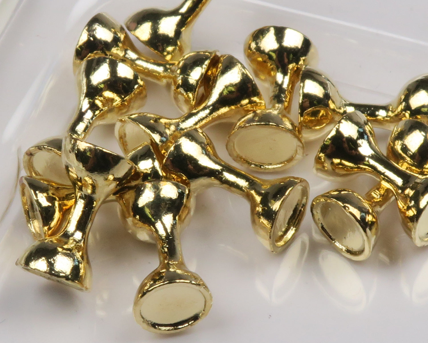 Gold flat-end tungsten eyes for fly tying, shiny metallic hourglass-shaped beads with flat faces