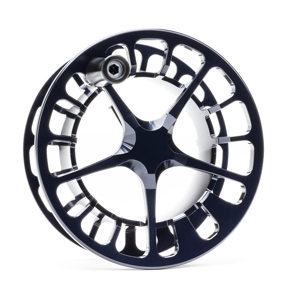 Lamson Guru X black and silver fly reel with large arbor design and polished aluminum frame displayed on white background
