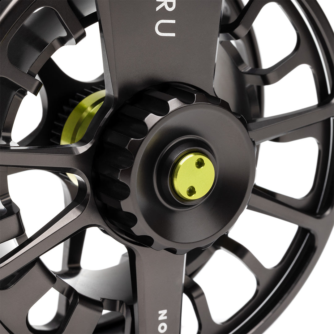 Lamson Guru X black fly reel with lime green center cap and large arbor design, front view detail