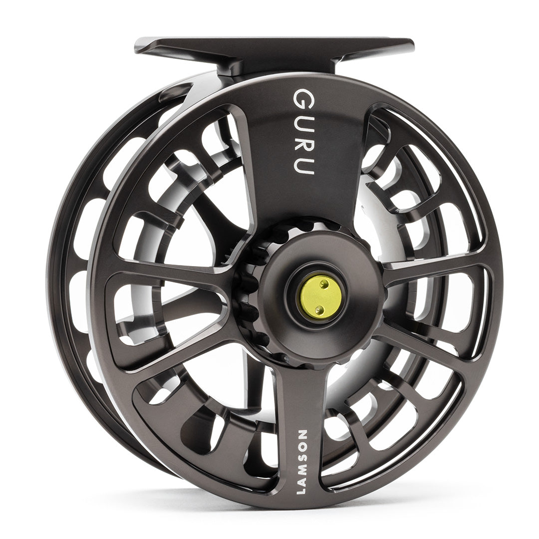 Lamson Guru X black fly reel with large arbor design and yellow drag knob, featuring skeletal frame and precision