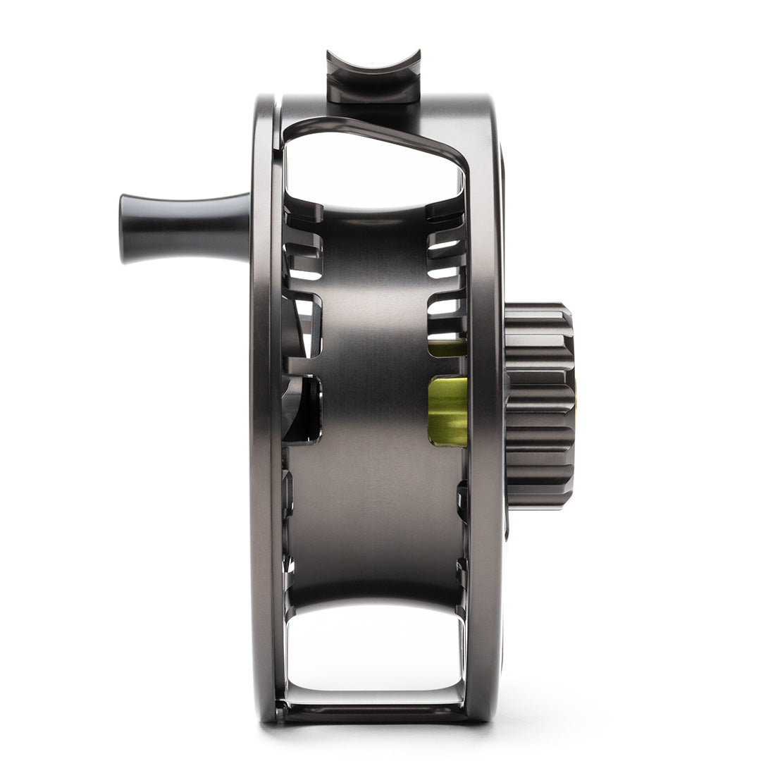 Lamson Guru X fly reel side view showing gunmetal gray aluminum body with black components and exposed gear mechanism
