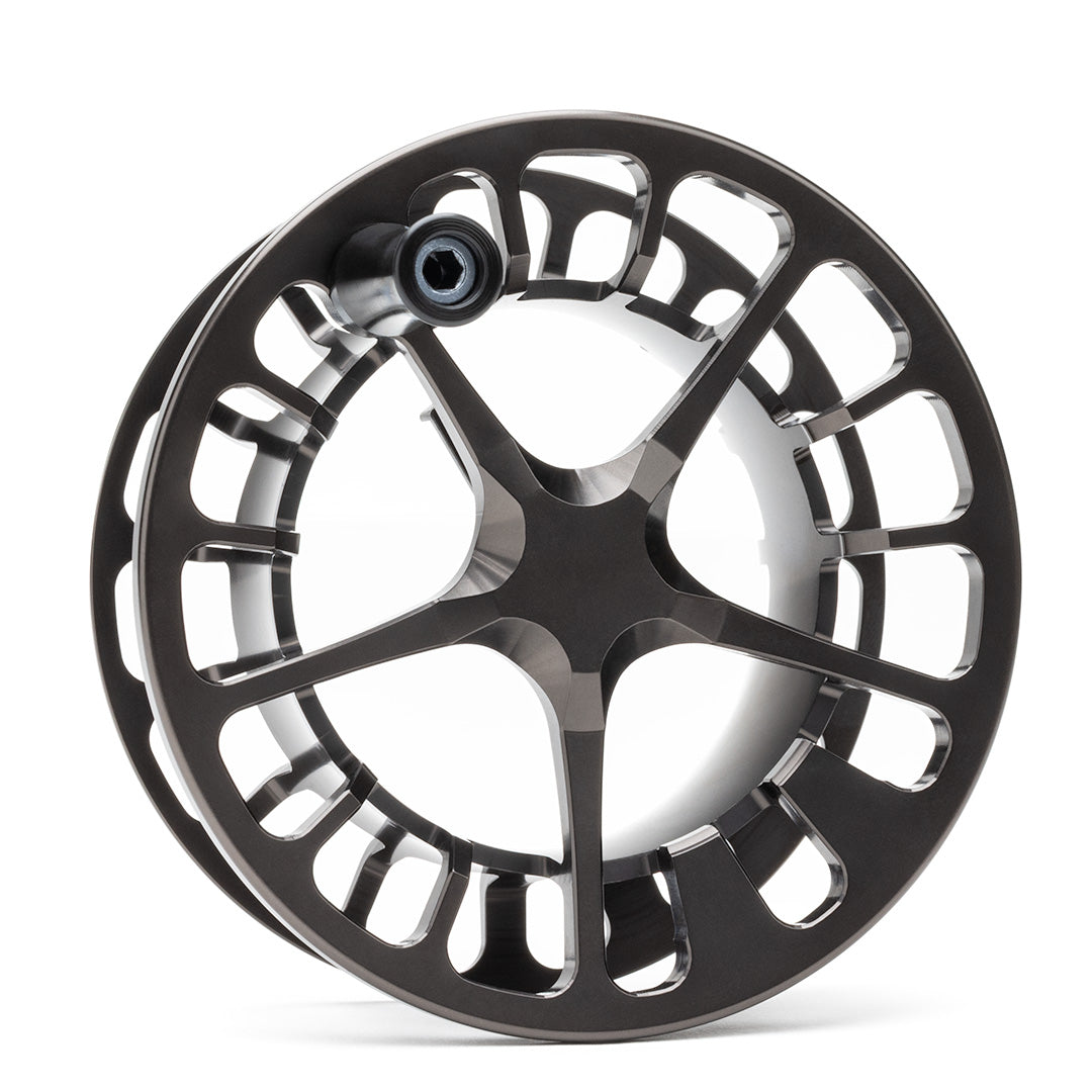 Black Lamson Guru X fly reel with large arbor design and skeletal frame structure, featuring machined aluminum construction