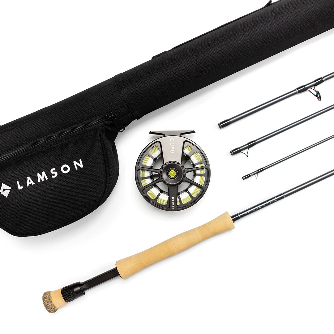 Lamson Guru fly rod outfit with black rod tube, anodized reel, cork handle, and spare rod sections on white background