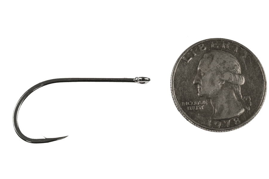 Dark bronze fly tying hook with a silver bead-style eye beside a 1978 Washington quarter for scale