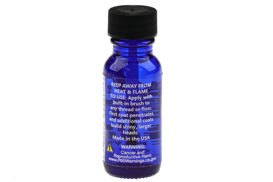 Blue glass bottle of Hareline Hard As Hull head cement for fly tying, with black cap and built-in brush label