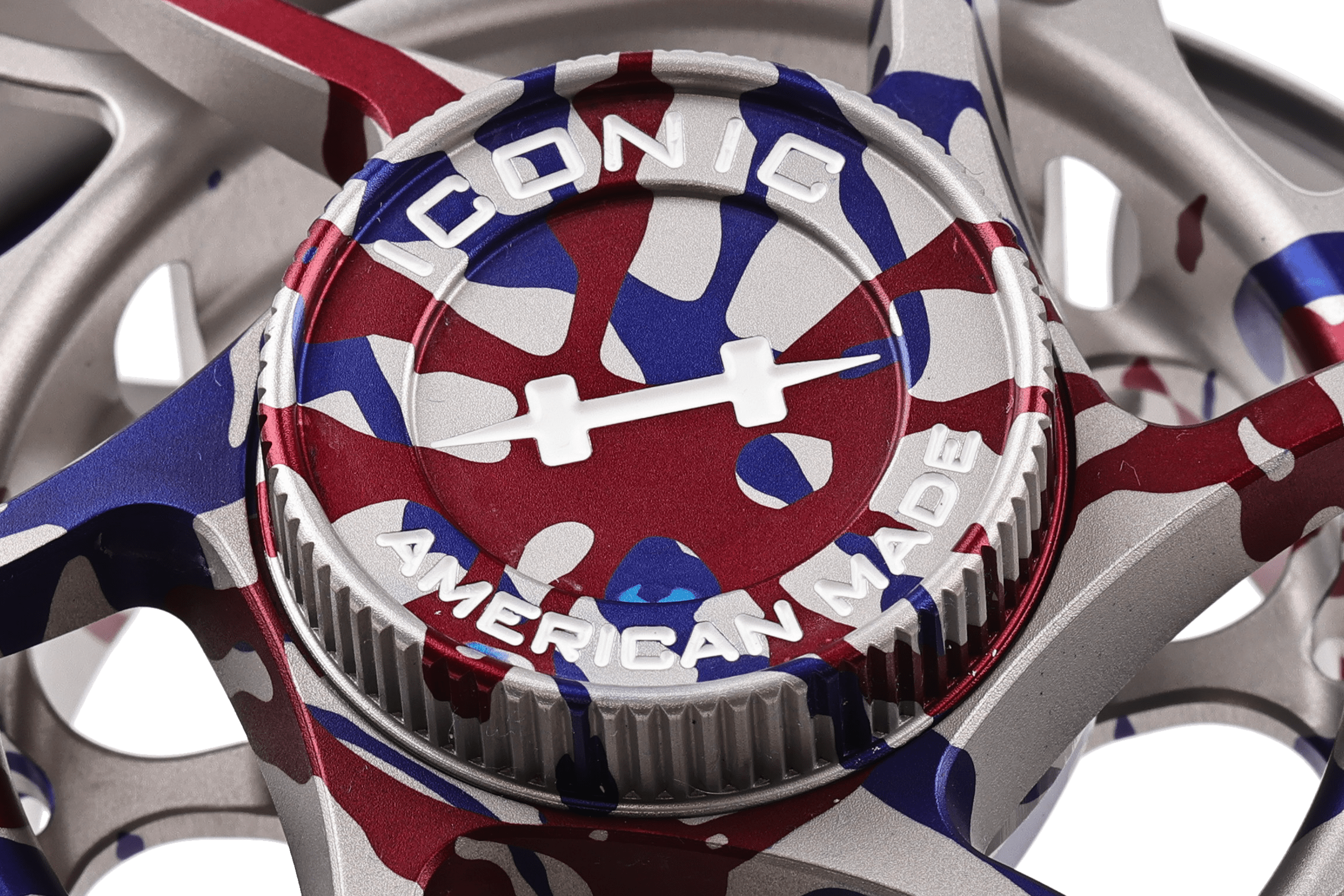 Hatch Iconic 250th fly reel closeup with red, white and blue anodized camo finish and machined drag knob