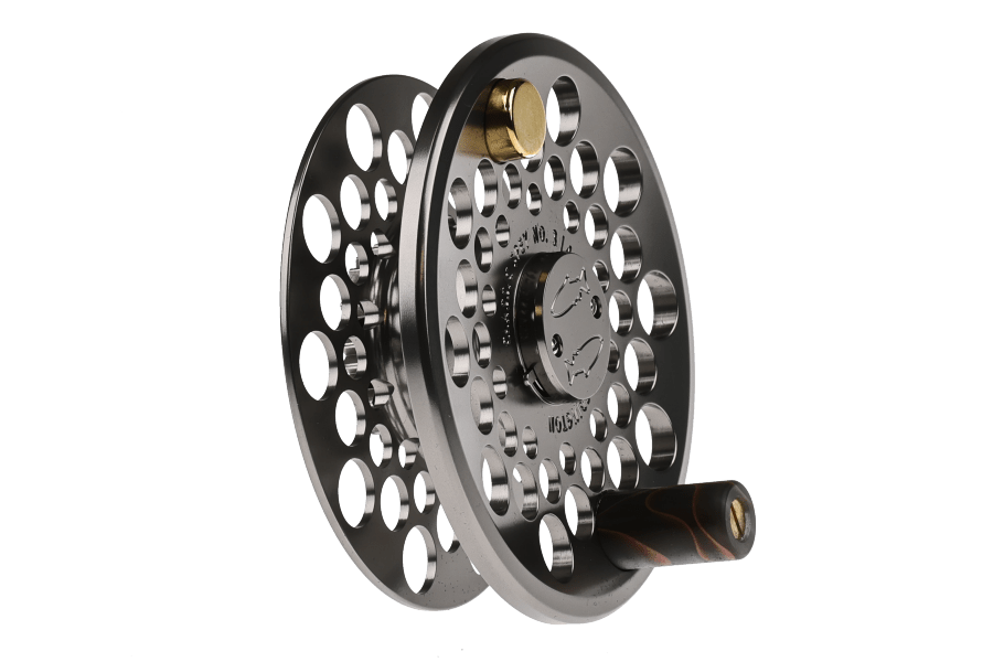 Gunmetal fly fishing reel spare spool with large perforated aluminum discs, brass drag knob, and dark wood-grain handle.
