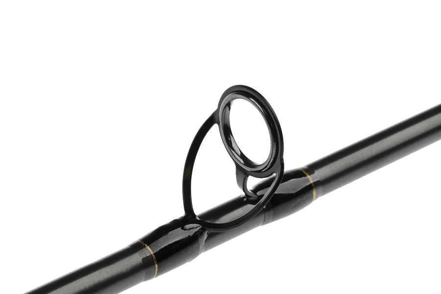 Black TFO Legacy fly rod blank with a black frame stripping guide and gold wraps on glossy graphite rod section against